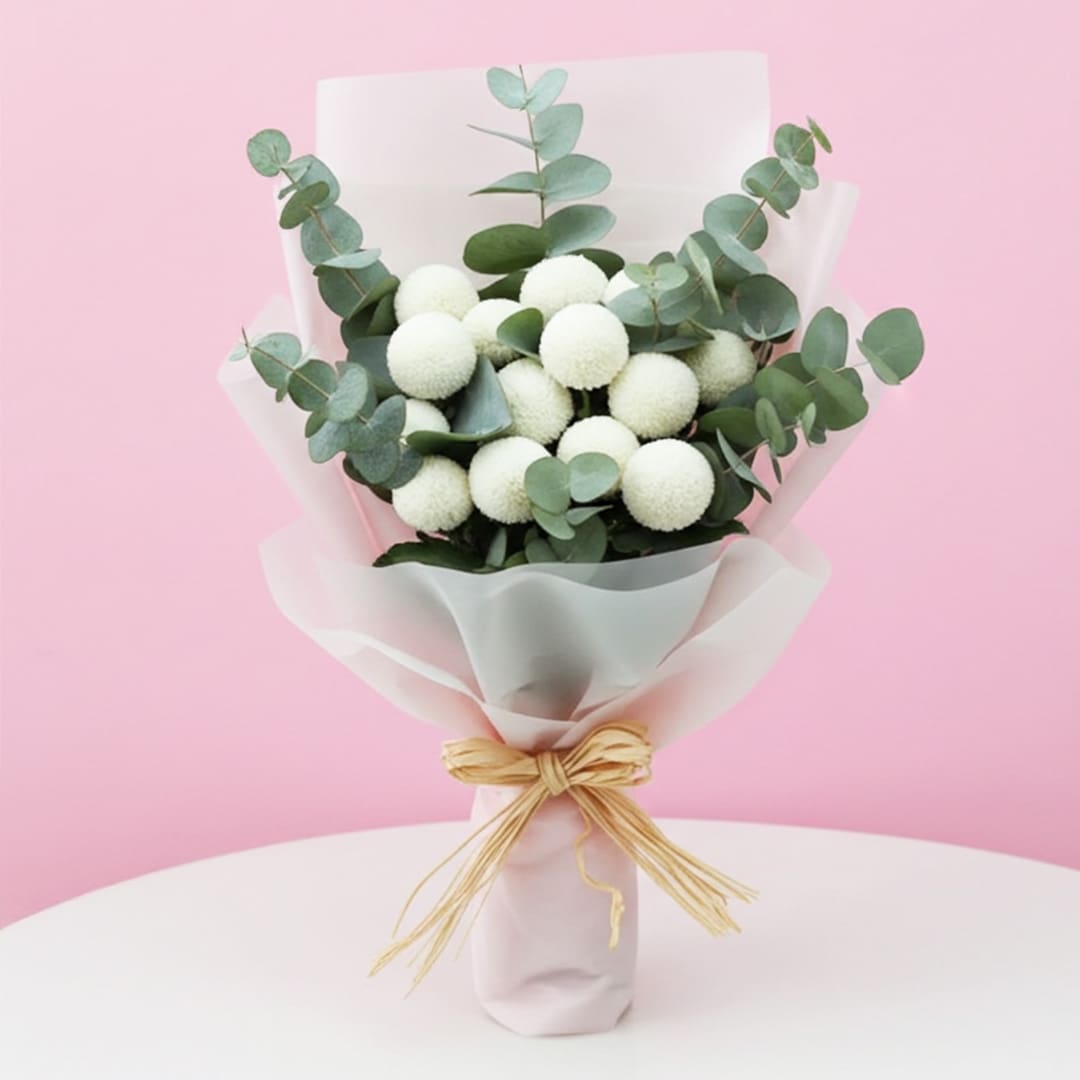 Bouquet of White Ping Pong-01-03-12-25 A hand bouquet featuring white flowers and eucalyptus leaves, elegantly arranged for a fresh and natural look.