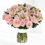 Pink mixed flower bunch in a glass vase.
