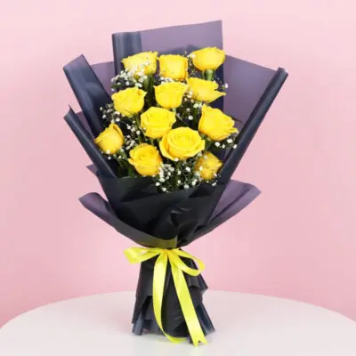 A bouquet of 12 vibrant yellow roses tied with a delicate yellow ribbon.