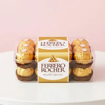 Ferrero Rocher chocolates displayed in a clear box, featuring their iconic gold foil and rich, layered design.