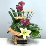 Celosia and other mixed flower arrangement in a box.