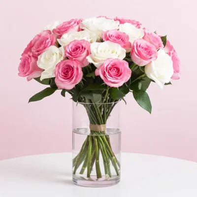 A vase filled with pink and white roses, showcasing a vibrant floral arrangement.