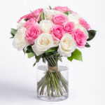 Pink and White roses in a glass vase.