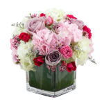 "Pretty of Roses and Hydrangeas" in a square vase.