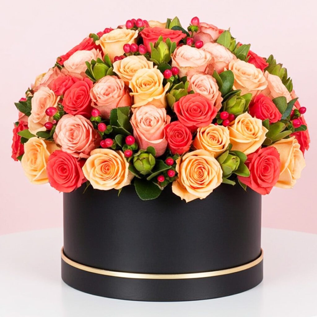 A large black box filled with vibrant orange and red roses, creating a striking floral display.