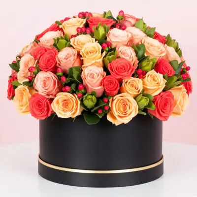 A large black box filled with vibrant orange and red roses, creating a striking floral display.