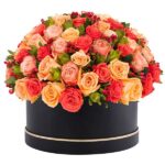Mixed color roses in a black box.