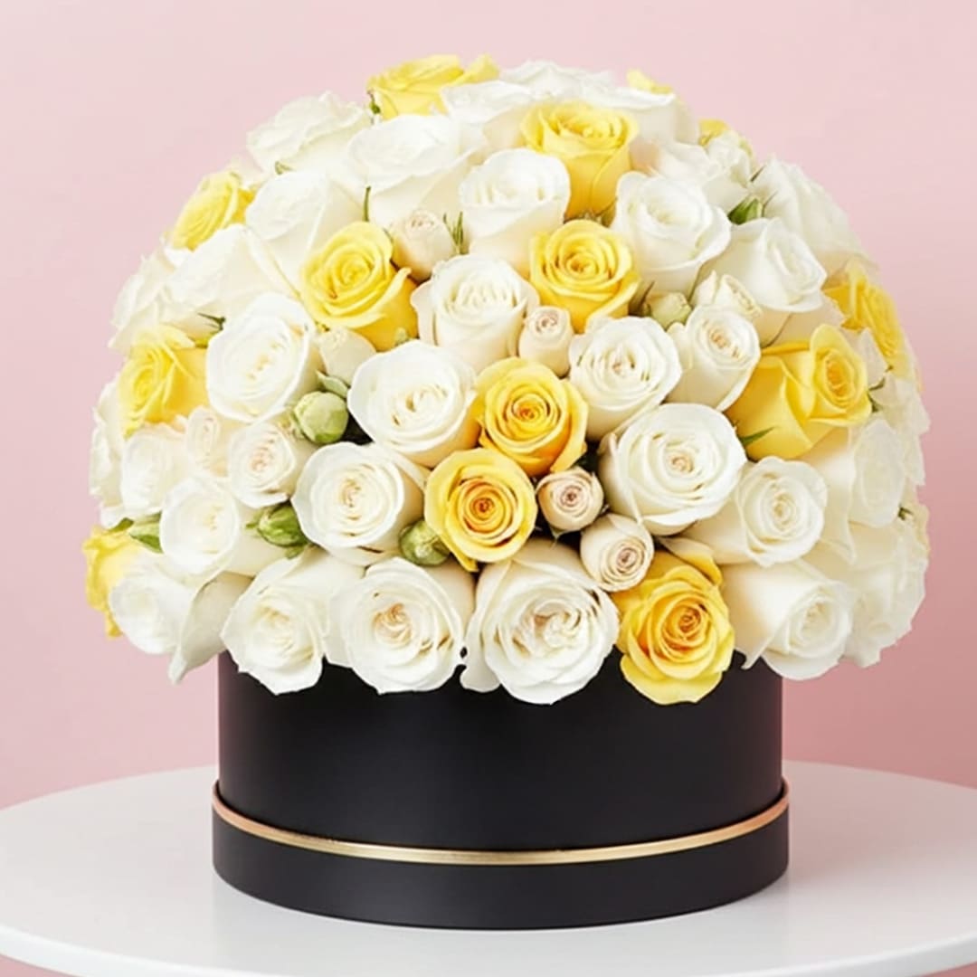 Signature Box of White and Yellow Roses-01 A large arrangement of red roses displayed in an elegant black box.