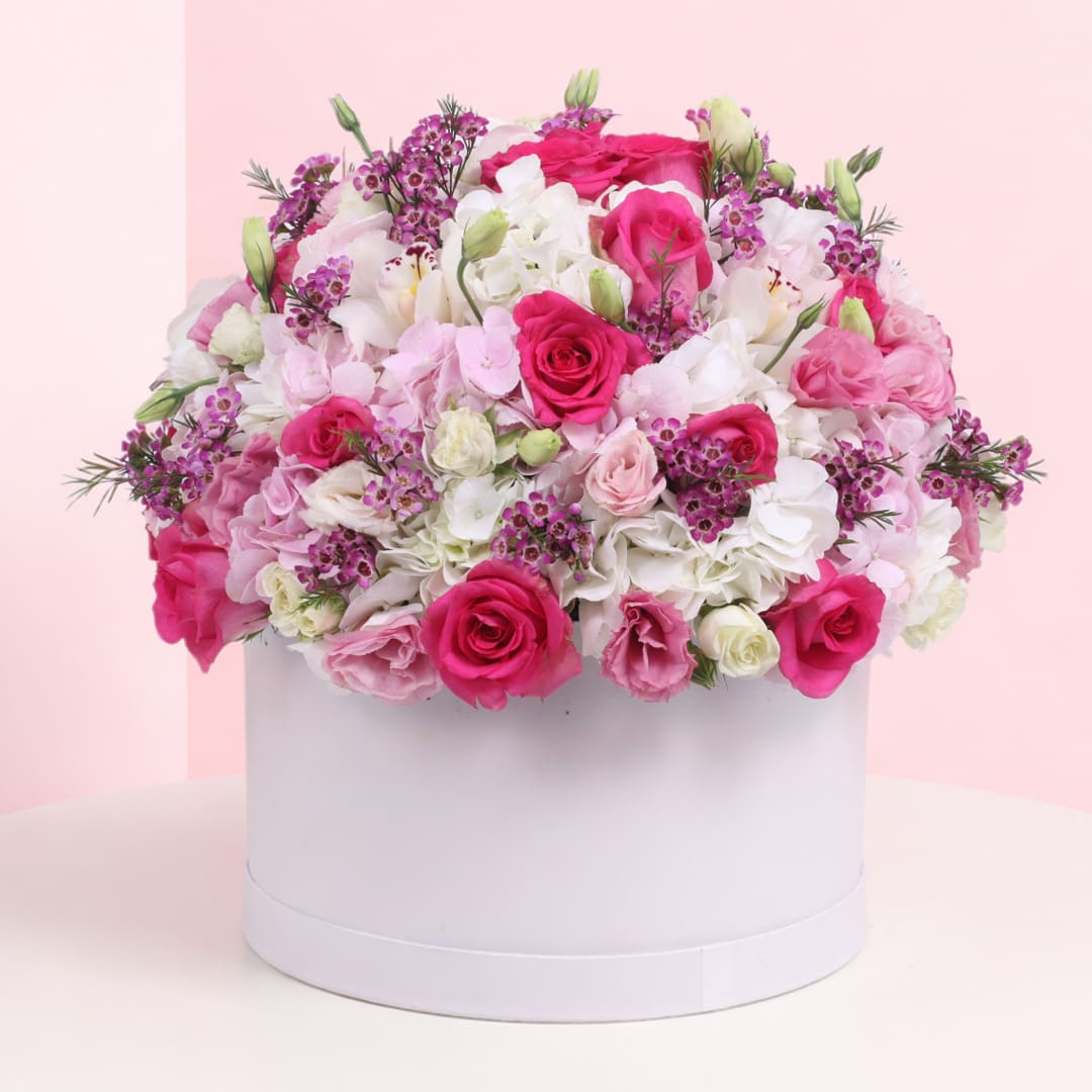 box-of-blooms-2026 Floral arrangement showcasing 8 dark pink roses, 8 white spray roses, 5 light pink spray roses, and white hydrangeas.