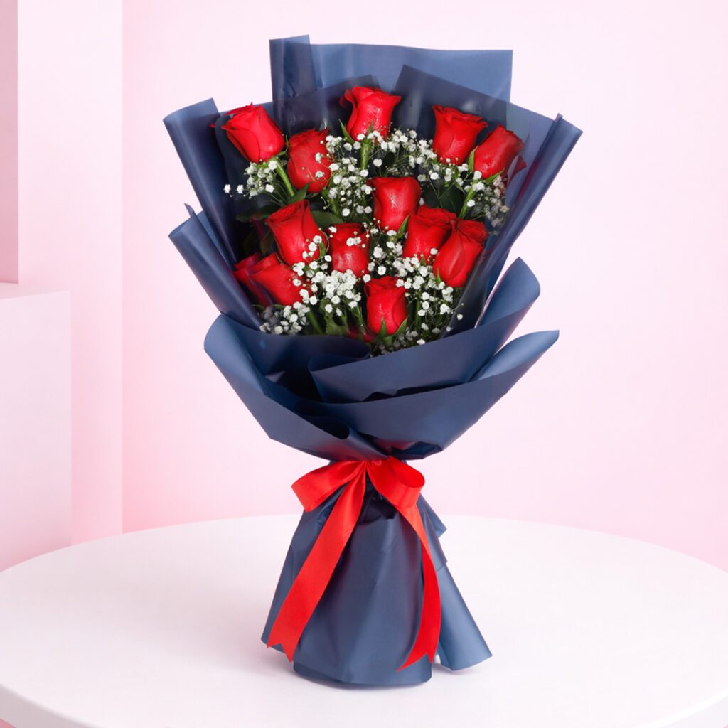Designer bouquet featuring 12 vibrant red roses, symbolizing love and passion, elegantly arranged for a romantic touch.