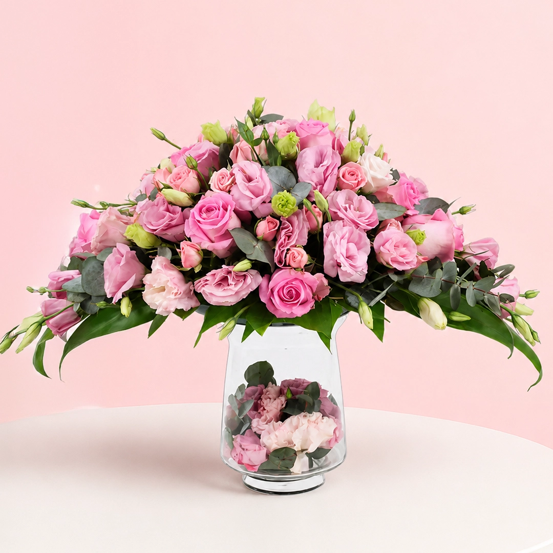 fantasy-of-lavish-pink-rose-arrangement_2026 A lavish arrangement of pink roses in various shades, elegantly displayed in a decorative vase.