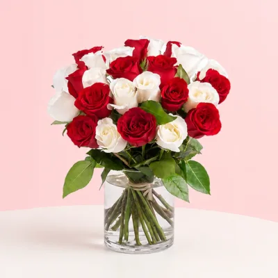 A bouquet of 8 red and 8 white roses in a cylinder vase, accompanied by a heartfelt message card, symbolizing love.