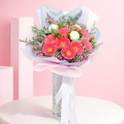 A charming bouquet of pink and purple roses presented in a rustic brown paper bag, highlighting floral elegance and craftsmanship.