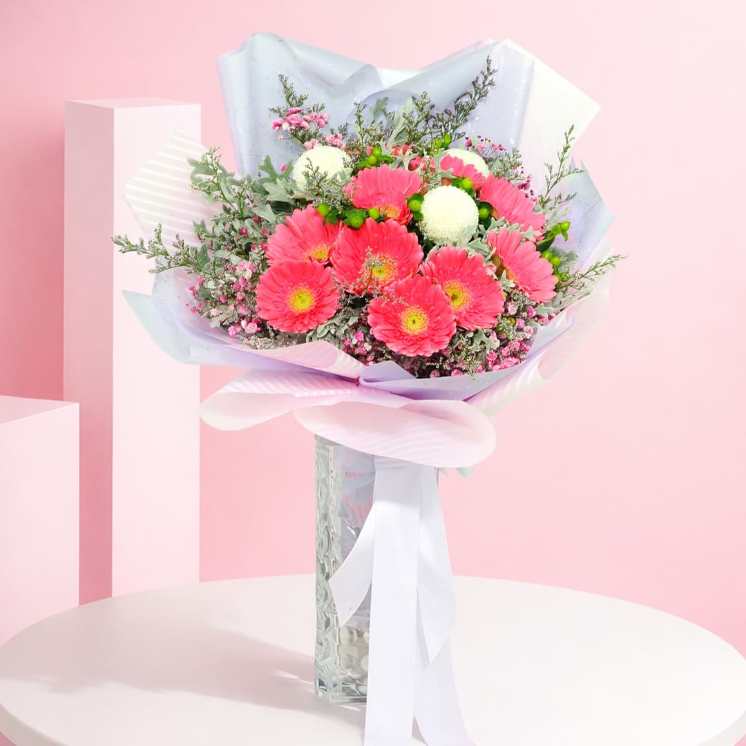 pretty-in-pink-bouquet-2026 A charming bouquet of pink and purple roses presented in a rustic brown paper bag, highlighting floral elegance and craftsmanship.