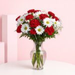 A decorative vase showcasing a beautiful arrangement of red and white surprise flowers, perfect for expressing affection.