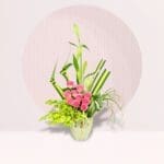 Ikebana pink roses arrangement with orchids, Mad Lily and seasonal greenery in a decorative vase