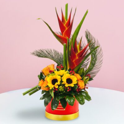 A vibrant flower arrangement displayed in a sleek gray box, showcasing a variety of colorful blooms.