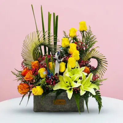 A vibrant flower arrangement displayed in a sleek gray box, showcasing a variety of colorful blooms.