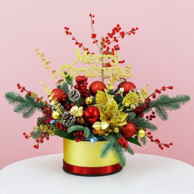 A festive red and gold Christmas arrangement beautifully presented in a decorative box.