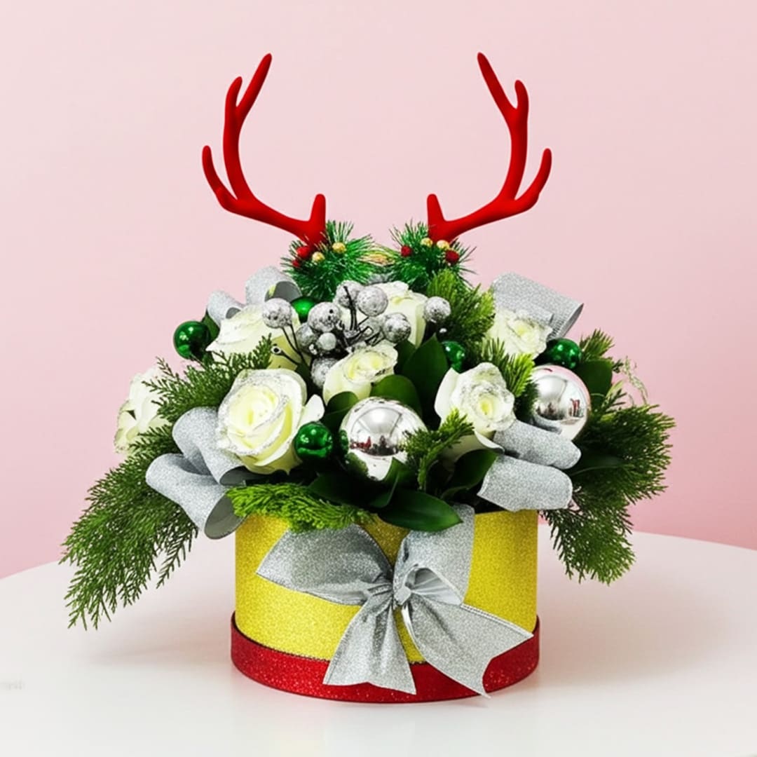 Xmas Deer Snow Bouquet-01-25 A holiday centerpiece with a bouquet of green leaves and deer antlers, arranged beautifully in a decorative box.