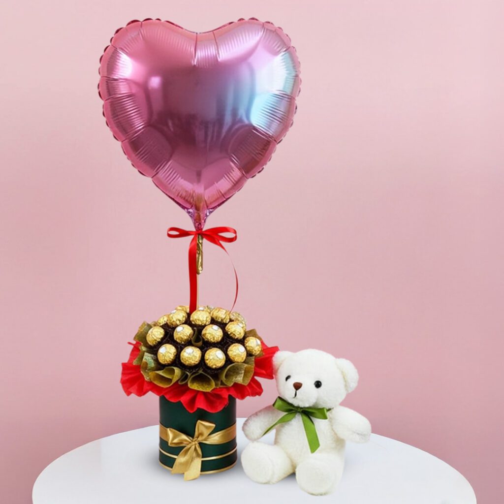 A teddy bear sits beside a heart-shaped balloon, both placed in a decorative vase.