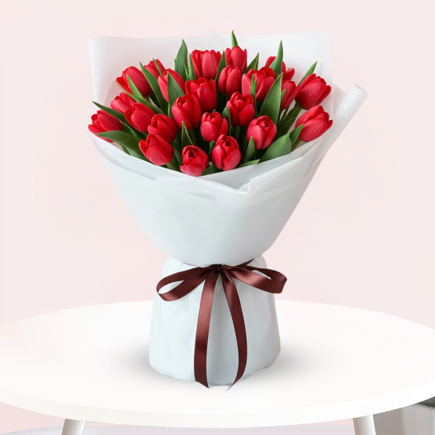 Red Tulips Bouquet-01 A vibrant bouquet of red tulips tied with a brown ribbon, showcasing their fresh blooms and elegant arrangement.