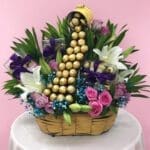 A basket overflowing with assorted chocolates and vibrant flowers, creating a delightful and colorful arrangement.