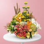 A vibrant bouquet of assorted flowers arranged elegantly on a wooden table.