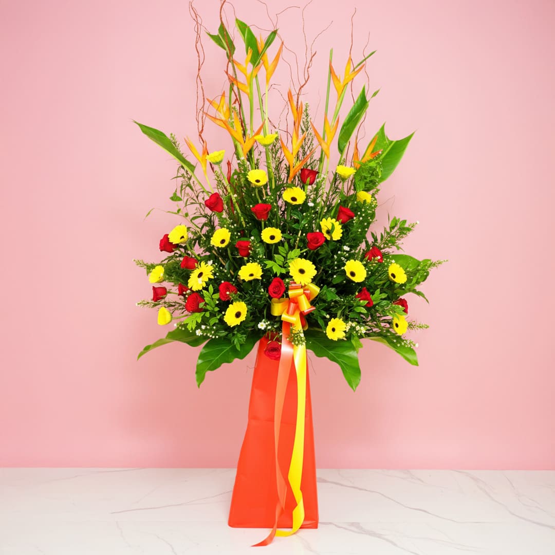 grand-fantasy-25 Radiant Success grand opening flower stand with red and yellow flowers, heliconia and fresh greenery.