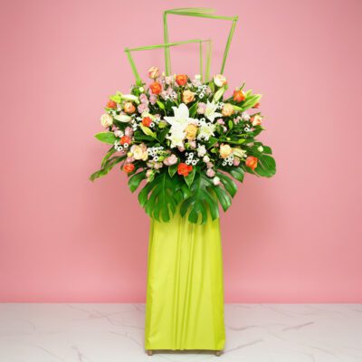 A Large Floral Arrangement Featuring 20 Roses, 5 Casa Lilies, 10 Eustomas, And Seasonal Greenery.