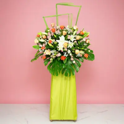 A Large Floral Arrangement Featuring 20 Roses, 5 Casa Lilies, 10 Eustomas, And Seasonal Greenery.