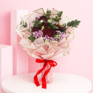 A bouquet of 13 vibrant red roses, elegantly arranged to create a stunning Crimson Blush display.