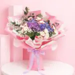Hand bouquet composed of 2 hydrangeas and 8 spray roses in various colors, embodying peace and the essence of nature.