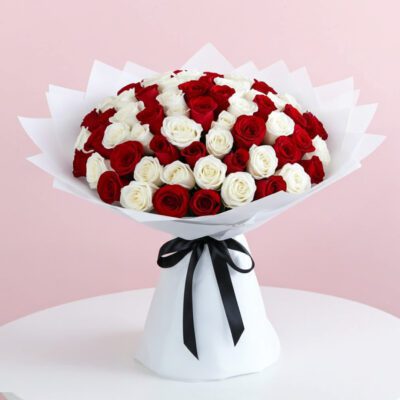 A bouquet featuring 100 red and white roses, elegantly arranged for a vibrant display.