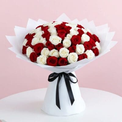 A bouquet featuring 100 red and white roses, elegantly arranged for a vibrant display.