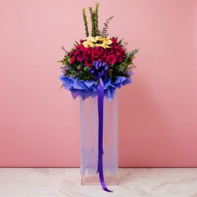 A majestic floral arrangement in a pink background, designed to impress at grand openings and celebrations.