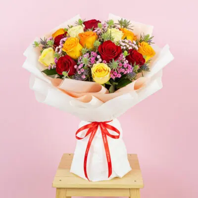 A vibrant bouquet of red roses surrounded by delicate sprigs of baby's breath.