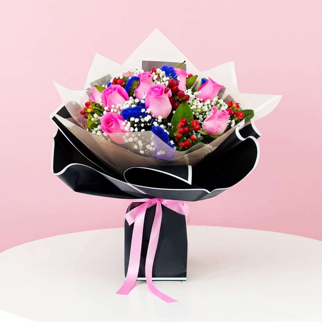 Colourful Surprise-04-12-5801 A hand bouquet of pink and blue roses with baby breath and cherry, presented in a black paper bag.