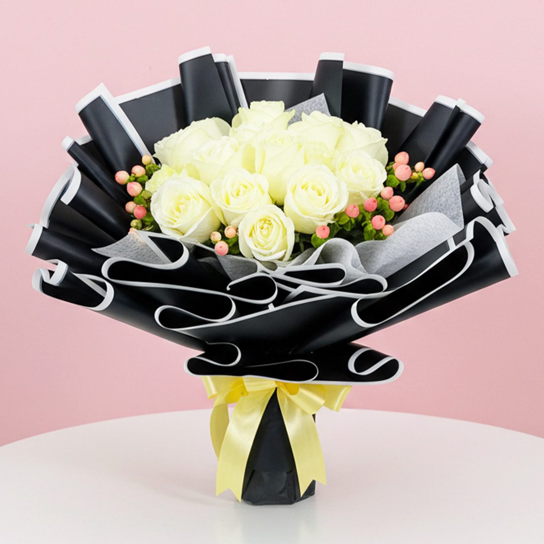 Sun-Kissed Petals of Yellow Blossoms!-01-25 A bouquet of white roses tied with a yellow ribbon, elegantly arranged for a special occasion.