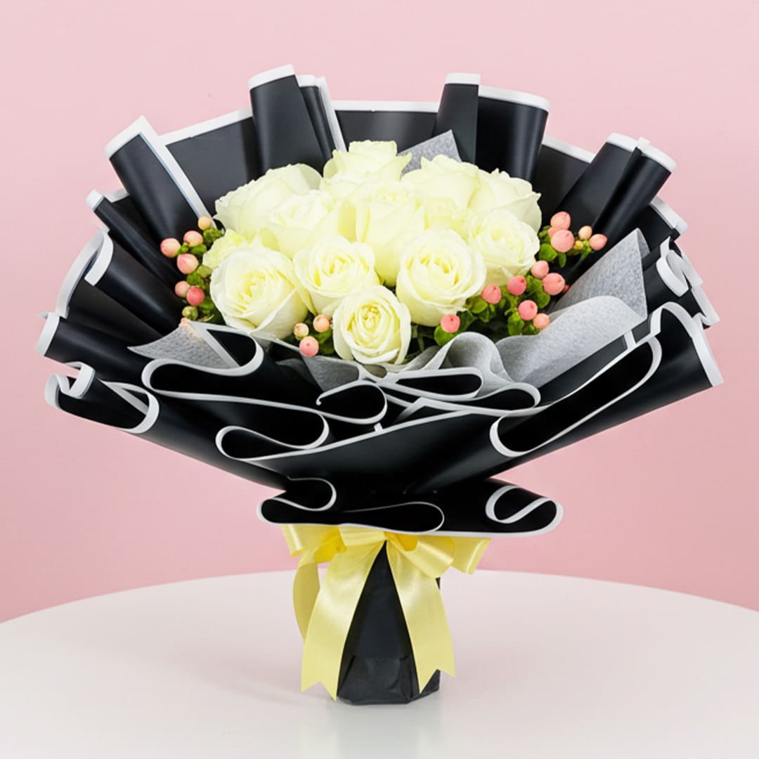 Sun-Kissed Petals of Yellow Blossoms!-01-25 A bouquet of white roses tied with a yellow ribbon, elegantly arranged for a special occasion.
