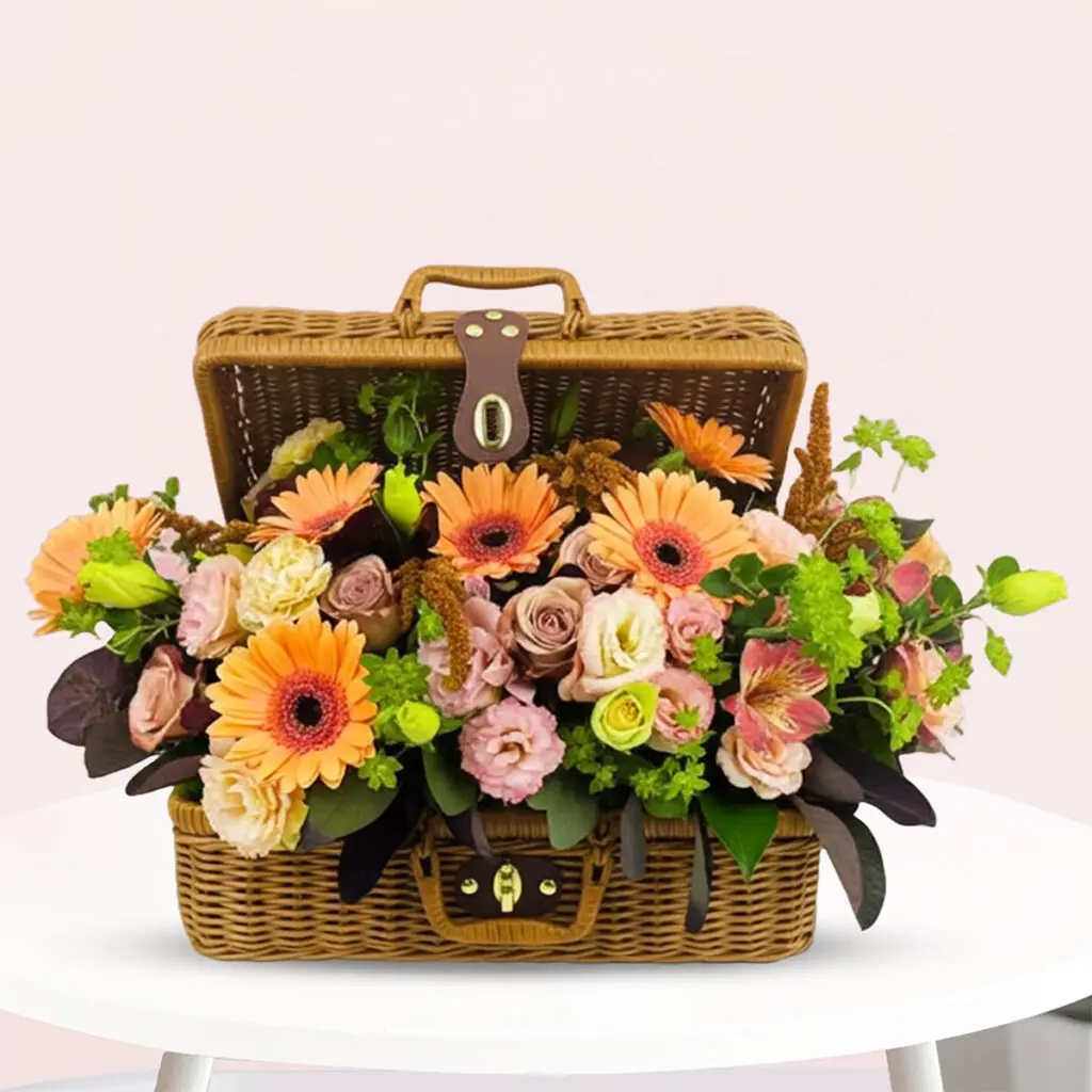 A basket filled with colorful flowers sits elegantly on a wooden table