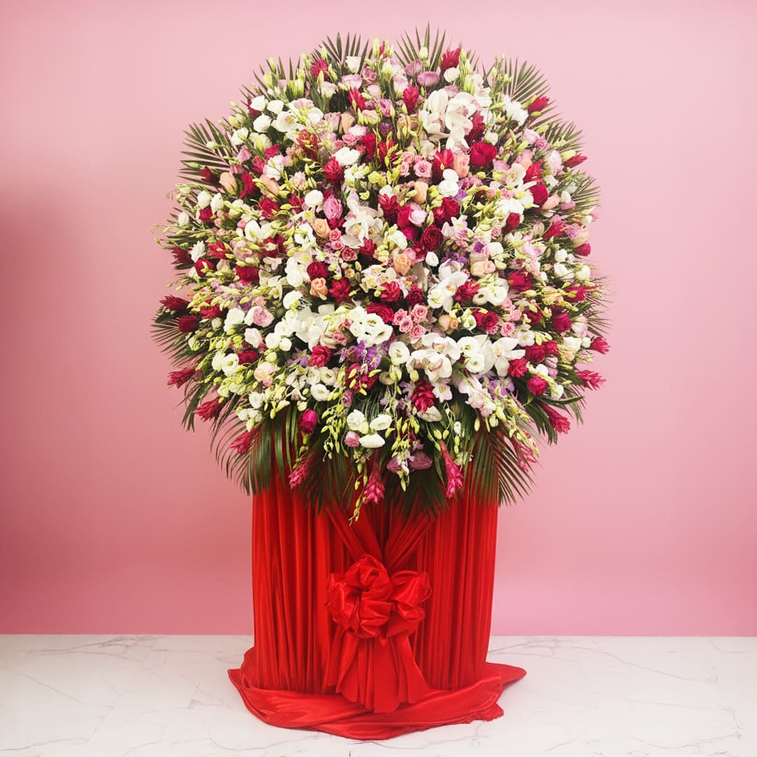 Gorgeous Blushing Floral Creation Gorgeous Blushing grand opening flower stand with pink, red and yellow flowers and golden balloons