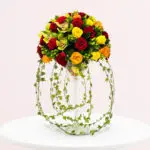 A vibrant bouquet of assorted flowers arranged in a clear glass vase.