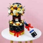 A wine bottle beside a colorful flower arrangement on a wooden table, creating an elegant dining atmosphere.