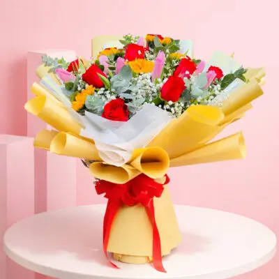 Colorful hand bouquet with 10 tulips, 10 roses, and 5 sunflowers, showcasing a bright spectrum of love and happiness.