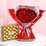 A bouquet of red roses alongside Ferrero Rocher chocolates, symbolizing love and appreciation in a beautiful gift arrangement.