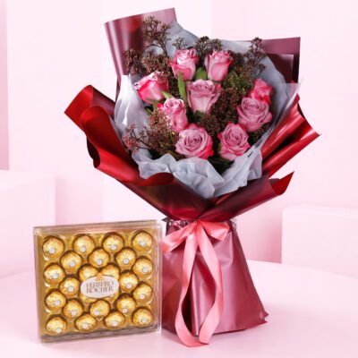 A vibrant bouquet of roses accompanied by a decorative box of chocolates, perfect for a romantic gift.