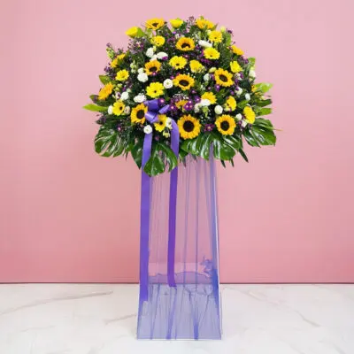 A Vibrant Display Of Sunflowers And Purple Flowers, Celebrating Joy At A Grand Opening Event.