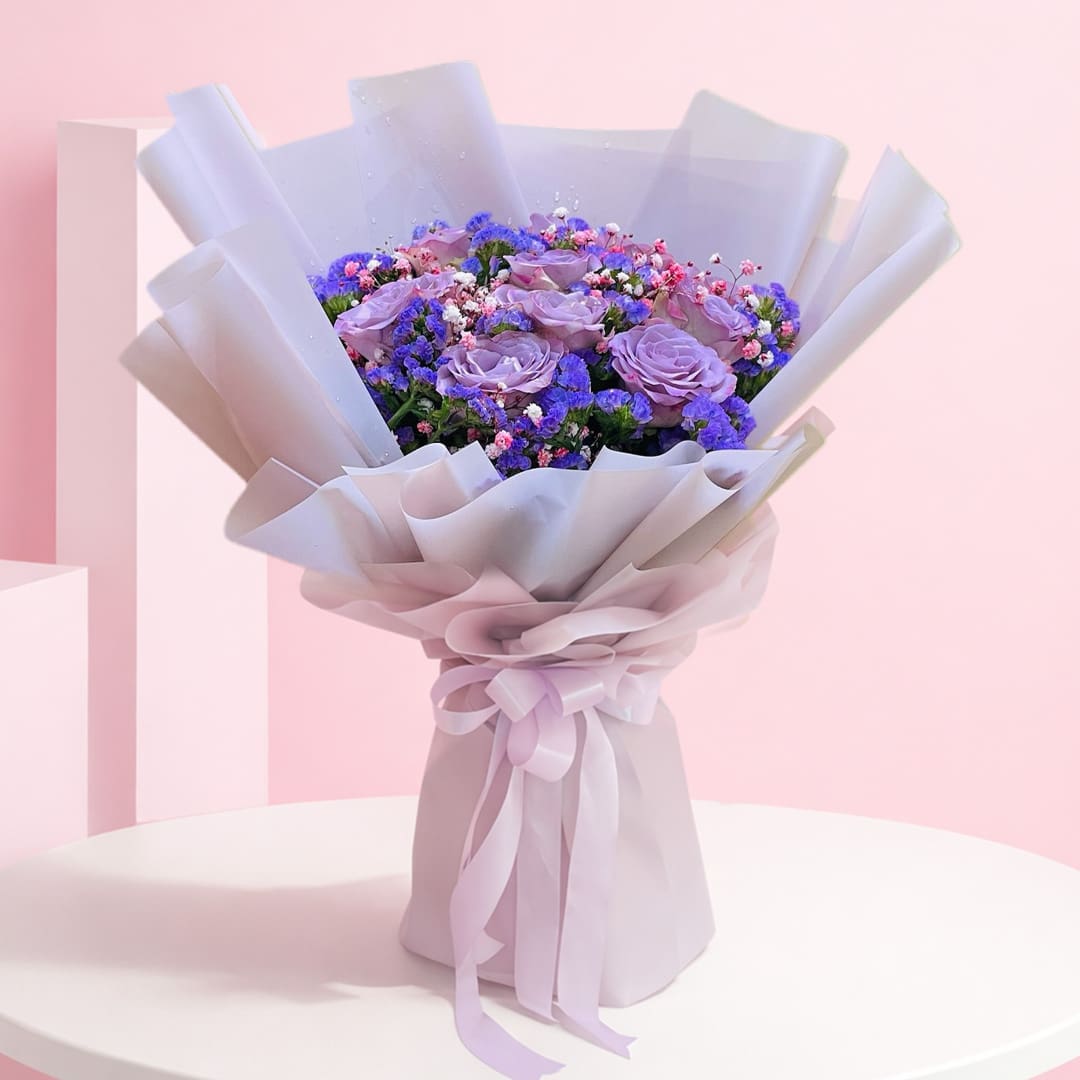 topaz-treasure-2026 A bouquet featuring vibrant purple roses alongside delicate blue flowers, arranged elegantly.