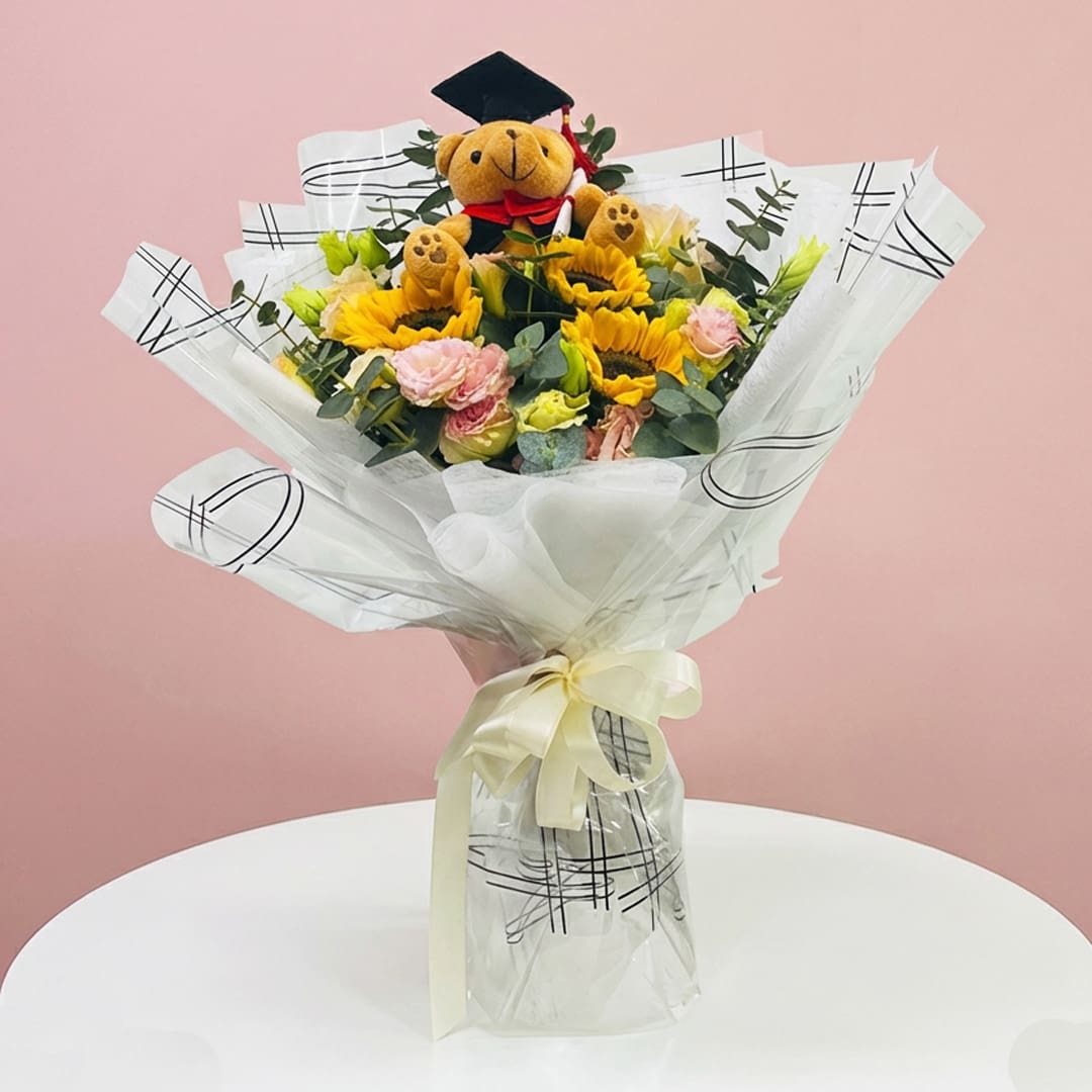 graduation-victory-bouquet-25 Raduation Victory Bouquet Featuring A Teddy Bear Surrounded By Colorful Flowers, Symbolizing Celebration And Achievement.